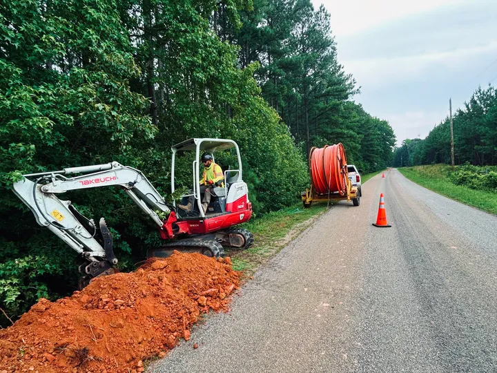 Mini excavator trenching